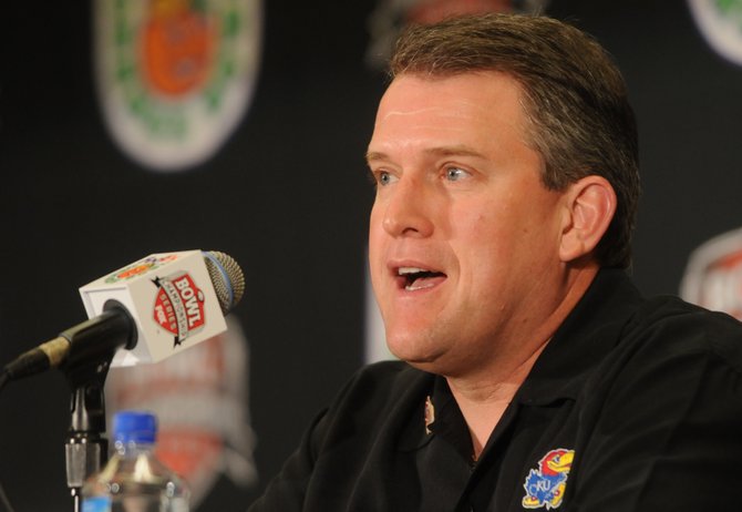 Former Kansas offensive coordinator Ed Warinner gives opening comments during a press conference Monday, Dec. 31, 2007 at the Hyatt Regency Hotel in Fort Lauderdale, Florida.