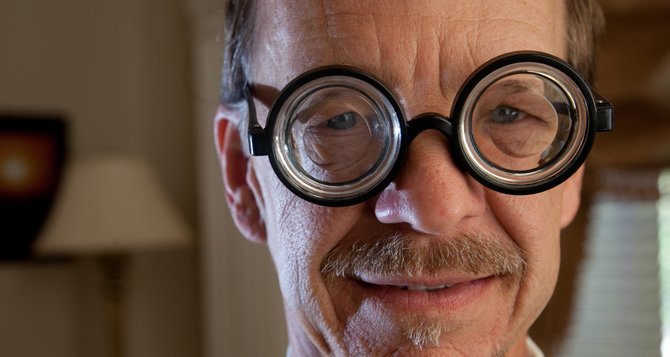 Mike Yoder models a pair of gag glasses in this demonstration involving the added effect of a rim light. The top photo was taken with Yoder standing about 2 feet from a window in an evenly lit room. The bottom photo, shot in the same location, has a rim light that is left of the camera and pointed to the back and left side of Yoder’s face as he faces the camera.