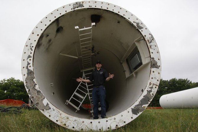 Lucas Chavey, an instructor at Cloud County Community College in wind energy, stands at the end of a turbine that once stood at Westar's Jeffrey Energy Center. The turbine was donated to the school so students in the Wind Energy Technology program could gain hands-on experience.