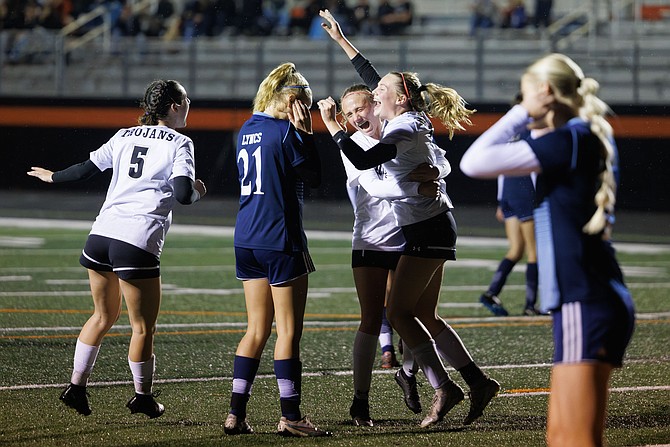 Meridian’s Morgan Adams raises her hands in celebration after scoring a goal as the Trojans shout out Lynden Christian 3-0 in a 1A District championship game on Nov. 1 in Blaine.